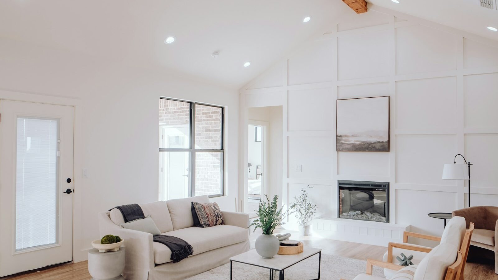 Bright coastal living room with fireplace in a model home