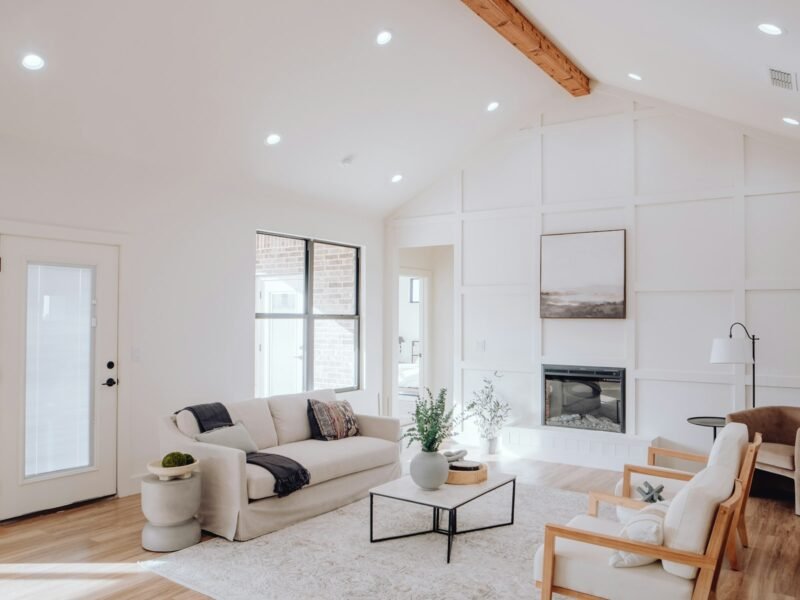 Bright coastal living room with fireplace in a model home