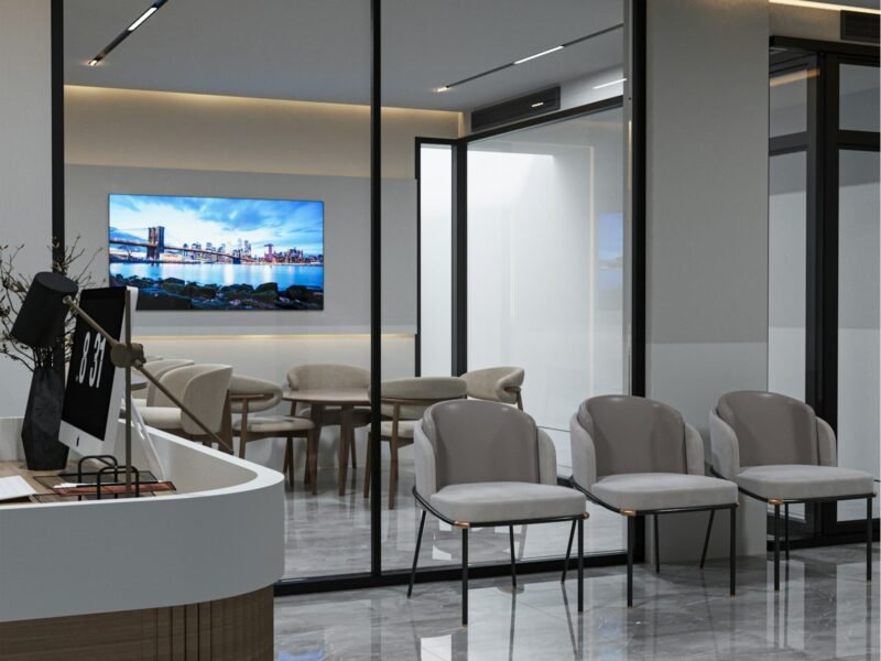 Modern commercial office meeting area with video conference screen