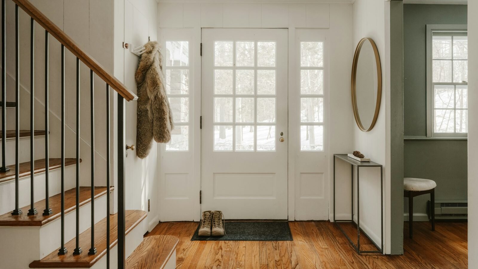 Warm home entryway with staircase and front door